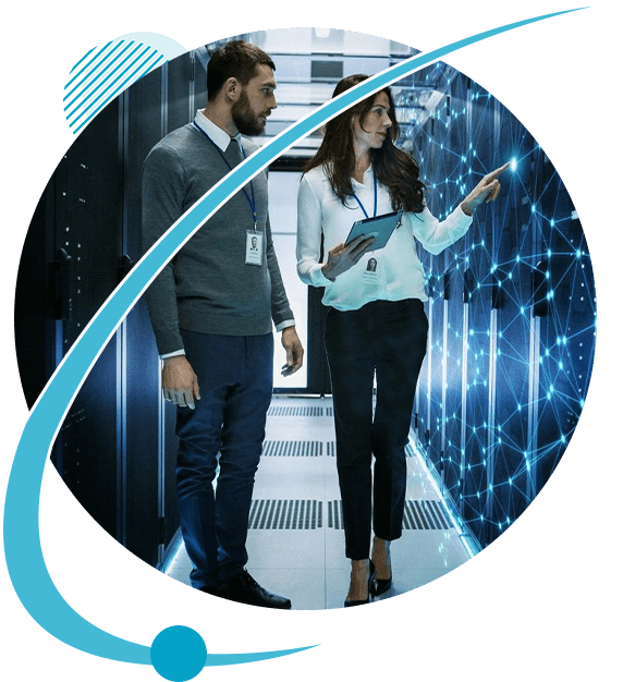 A man and woman standing in front of a server room.